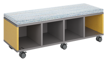 Load image into Gallery viewer, Mobile storage unit with four cubby columns, optional upholstered seat for seating, customizable laminate finishes, and casters for easy mobility.
