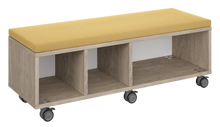 Load image into Gallery viewer, Mobile storage unit with a three column, tray and shelf configuration, optional upholstered seat for seating, customizable laminate finishes, and casters for easy mobility.

