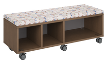 Load image into Gallery viewer, Mobile storage unit with a three column, cubby and shelf configuration, optional upholstered seat for seating, customizable laminate finishes, and casters for easy mobility.
